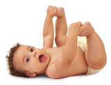 Happy baby lying on back wearing a cloth diaper, illustrating comfort and natural movement